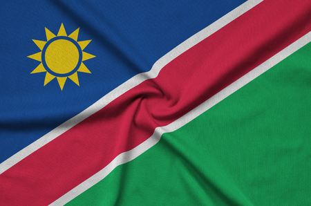 Namibia flag  is depicted on a sports cloth fabric with many folds. Sport team waving bannerの写真素材
