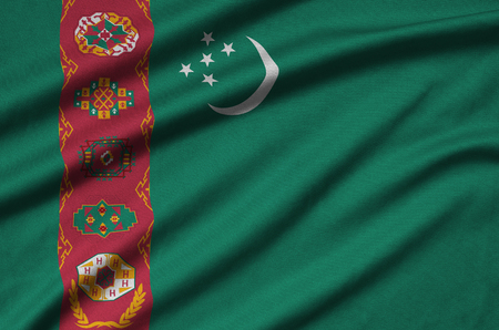 Turkmenistan flag  is depicted on a sports cloth fabric with many folds. Sport team waving bannerの写真素材
