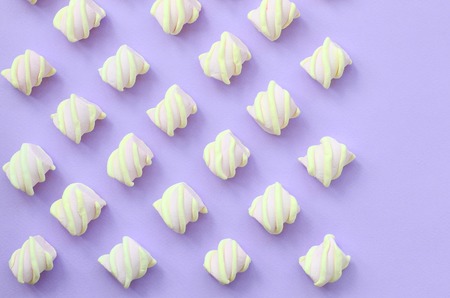 Colorful marshmallow laid out on violet paper background. pastel creative textures with copy space. minimal.の写真素材