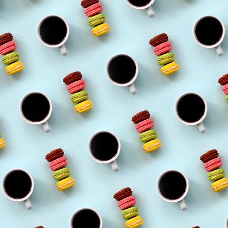 A pattern of many colorful dessert cake macaroon and coffee cups on trendy pastel blue background top view. Flat lay composition.の写真素材