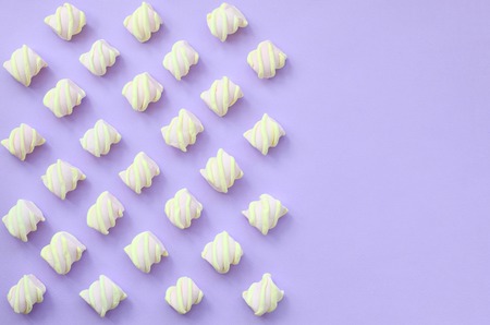 Colorful marshmallow laid out on violet paper background. pastel creative textures with copy space. minimal.の写真素材