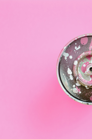 Used spray can with pink paint drips lie on texture background of fashion pastel pink color paper in minimal concept.の写真素材