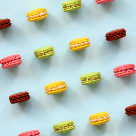 Dessert cake macaron or macaroon on trendy pastel blue background top view. Flat lay composition.の写真素材