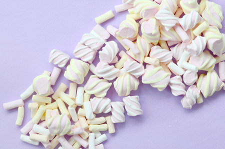 Colorful marshmallow laid out on violet paper background. pastel creative texture. minimal.の写真素材