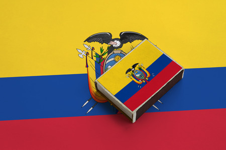 Ecuador flag  is pictured on a matchbox that lies on a large flag.の写真素材