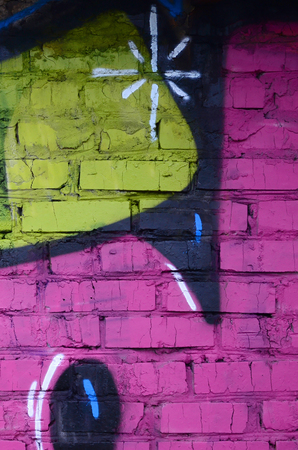 Fragment of graffiti drawings. The old wall decorated with paint stains in the style of street art culture. Colored background texture.の写真素材