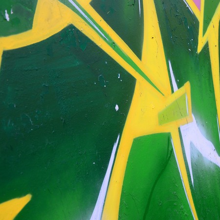 Fragment of graffiti drawings. The old wall decorated with paint stains in the style of street art culture. Colored background texture.の写真素材