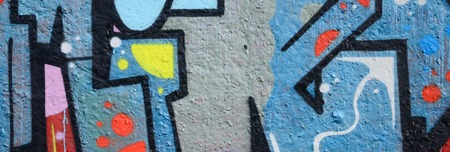 Fragment of graffiti drawings. The old wall decorated with paint stains in the style of street art...