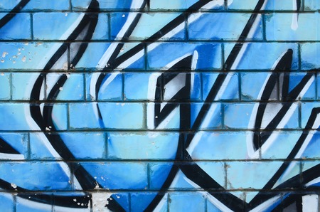 Fragment of graffiti drawings. The old wall decorated with paint stains in the style of street art...