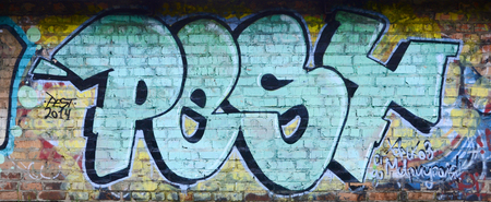 Full and acomplished graffiti artwork. The old wall decorated with paint stains in the style of street art culture. Colored background texture.の写真素材