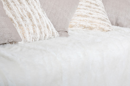 Many Pillows Lie On The Couch Which Is Covered With A Large Plush