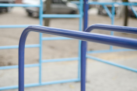 Sports bars in blue on the background of a street sports ground for training in athletics. Outdoor...