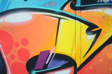 Fragment of graffiti drawings. The old wall decorated with paint stains in the style of street art...
