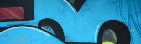 Fragment of graffiti drawings. The old wall decorated with paint stains in the style of street art culture. Colored background texture in cold tones.の写真素材