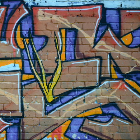 Fragment of graffiti drawings. The old wall decorated with paint stains in the style of street art...