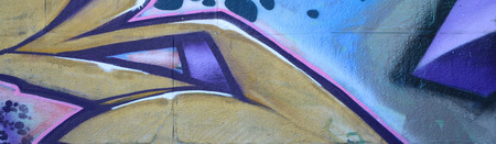 Fragment of graffiti drawings. The old wall decorated with paint stains in the style of street art...