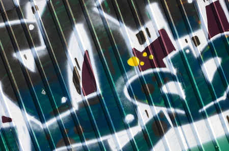 Fragment of graffiti drawings. The old wall decorated with paint stains in the style of street art...