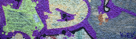 Fragment of graffiti drawings. The old wall decorated with paint stains in the style of street art...