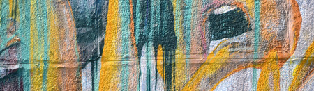 Fragment of graffiti drawings. The old wall decorated with paint stains in the style of street art...