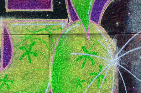 Fragment of graffiti drawings. The old wall decorated with paint stains in the style of street art...