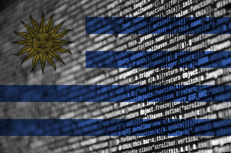 Uruguay flag  is depicted on the screen with the program code. The concept of modern technology and...