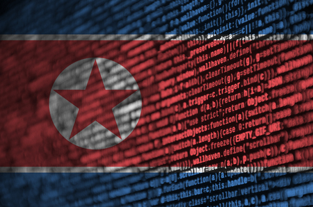 North Korea flag  is depicted on the screen with the program code. The concept of modern technology and site development.の写真素材