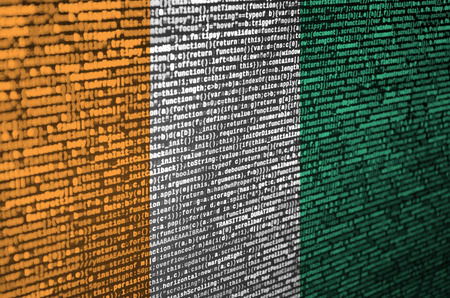 Ivory Coast flag  is depicted on the screen with the program code. The concept of modern technology and site development.の写真素材