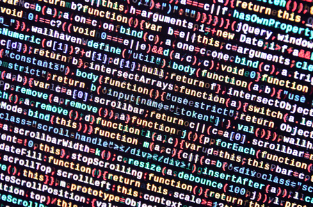 Writing programming code on laptop. Digital binary data on computer screen. Project managers work...