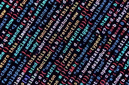 Writing programming code on laptop. Digital binary data on computer screen. Project managers work...
