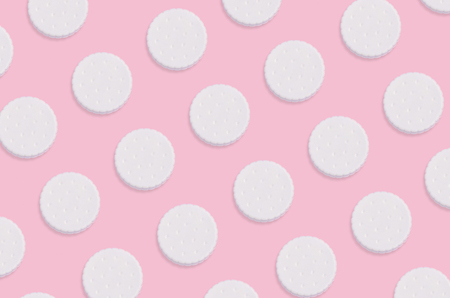 Creative art made with cookies pattern on pastel pink background. Minimalism flat lay top viewの写真素材
