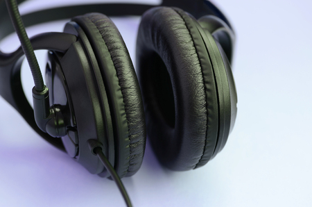 Black headphones lies on a colorful pastel violet background. Music listening conceptの写真素材