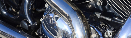 Close up fragment of chromed shiny body part of old classic motorbikeの写真素材