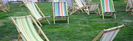 Chaise lounges on a lawn. Rest in the festival, on vacation. Garden sunbeds on green grass. Garden bed for sunbathing and rest. Summer chairの写真素材