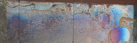Abstract corrosion texture on the copper plated steel sheet. Random pattern in orange and blue...