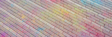 Multi colored earth, paving slabs, powder coated with dry colors at the Holi festival close up