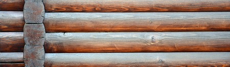 Hewn timber. Rustic log wall horizontal timber background. Fragment of unpainted wooden debarked logs. House wall wallpaper textureの写真素材