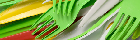 Pile of bright yellow, green and white used plastic kitchenware appliances. Ecological problem. Plastic pollutionの写真素材