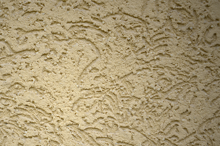 The texture of the beige decorative plaster in bark beetle style. Russian variation of decorating facade wallsの写真素材