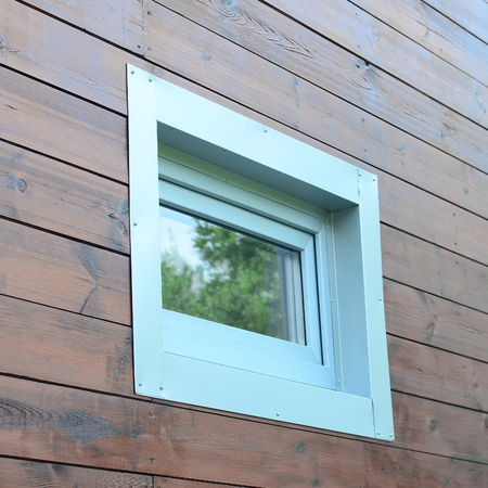 Plastic PVC window in modern passive wooden house facade wall. PVC windows are the number one in...