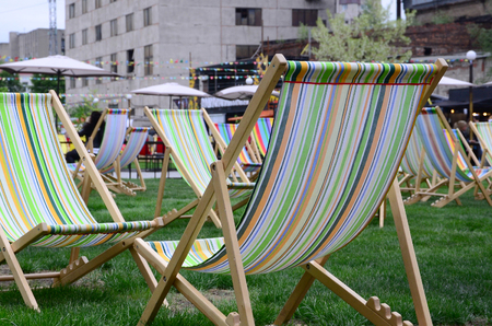 Chaise lounges on a lawn. Rest in the festival, on vacation. Garden sunbeds on green grass. Garden bed for sunbathing and rest. Summer chairの写真素材