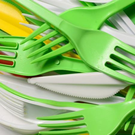 Pile of bright yellow, green and white used plastic kitchenware appliances. Ecological problem. Plastic pollutionの写真素材