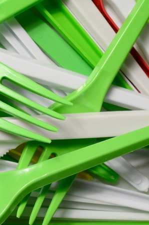 Pile of bright yellow, green and white used plastic kitchenware appliances. Ecological problem. Plastic pollutionの写真素材