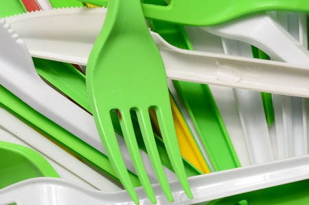 Pile of bright yellow, green and white used plastic kitchenware appliances. Ecological problem. Plastic pollutionの写真素材