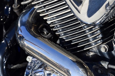 Close up fragment of chromed shiny body part of old classic motorbikeの写真素材