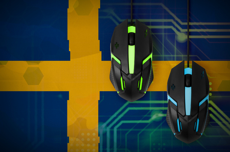 Sweden flag  and two modern computer mice with backlight. The concept of online cooperative games. Cyber sport teamの写真素材