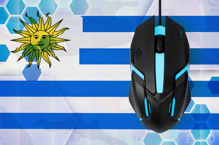 Uruguay flag  and modern backlit computer mouse. Concept of country representing e-sports teamの写真素材