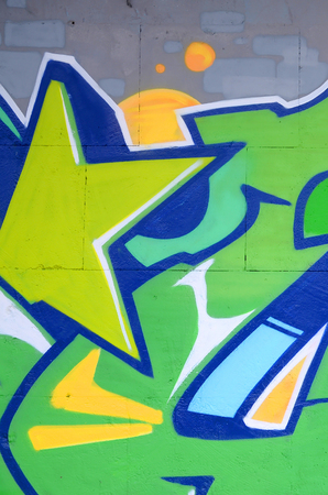 Fragment of colored street art graffiti paintings with contours and shading close up. Background texture of youth contemporary art culture. Green and yellow coloursのeditorial素材