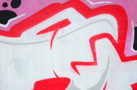 Fragment of colored street art graffiti paintings with contours and shading close up. Background texture of youth contemporary art culture. Pink red and black colorsのeditorial素材
