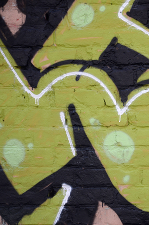 Fragment of colored street art graffiti paintings with contours and shading close up. Background texture of youth contemporary art culture. Green yellow colorsのeditorial素材