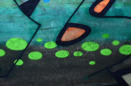 Fragment of colored street art graffiti paintings with contours and shading close up. Background texture of youth contemporary art culture. Green and yellow coloursのeditorial素材